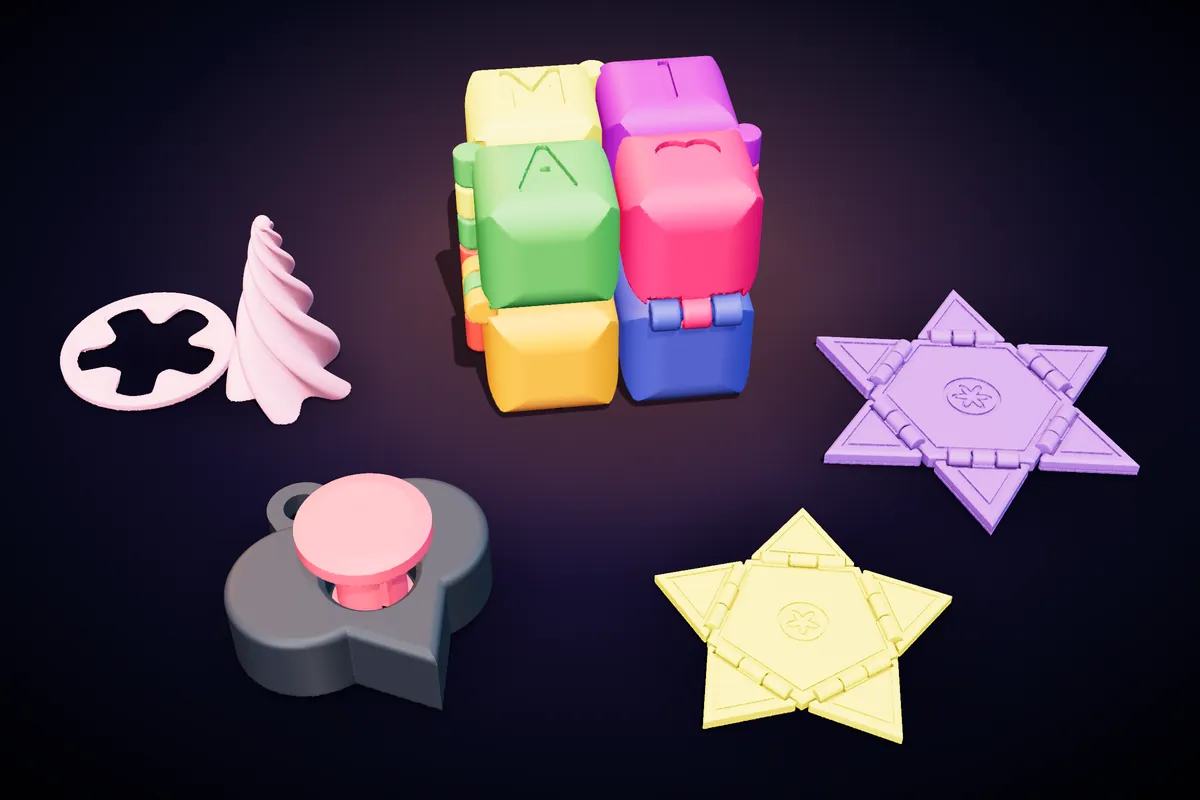 A colourful infinity cube with a name, purple and yellow flip stars, a spiral cone and a heart clicker keychain
